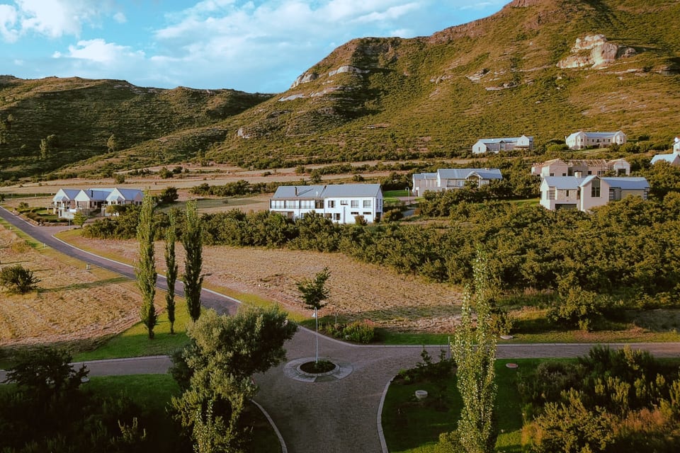Estate homes beneath the sandstone cliffs