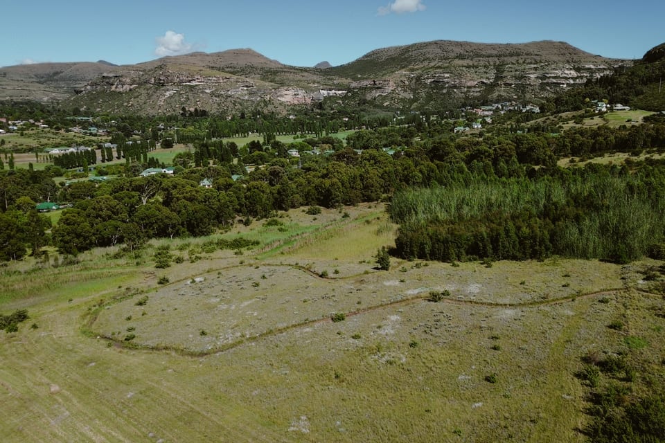 Open estate land below the sandstone cliffs, with stands still to be built on