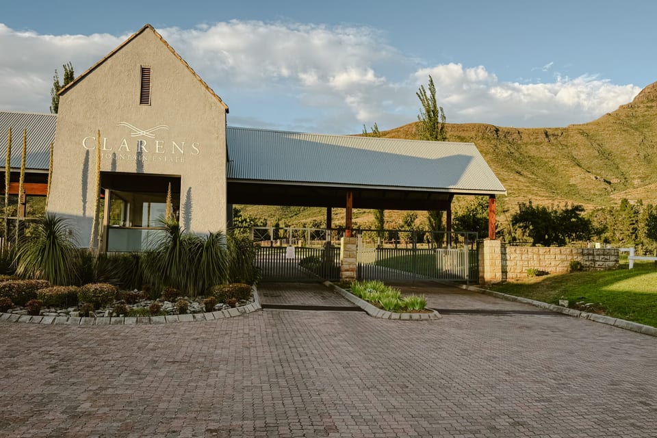 The manned gatehouse and paved entrance driveway to the estate
