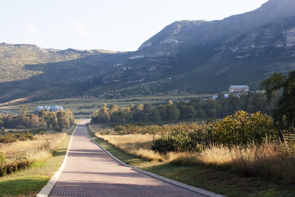 A quiet road running straight toward the mountains