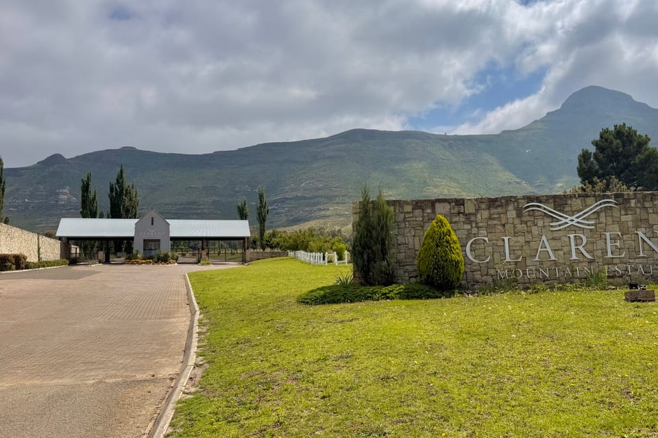 The stone entrance wall to Clarens Mountain Estate beside the access road
